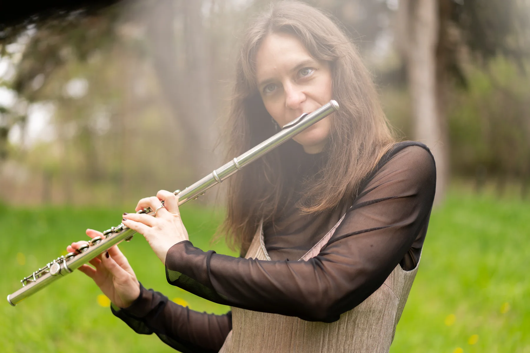 Lisa Pulsatilla playing flute outdoors