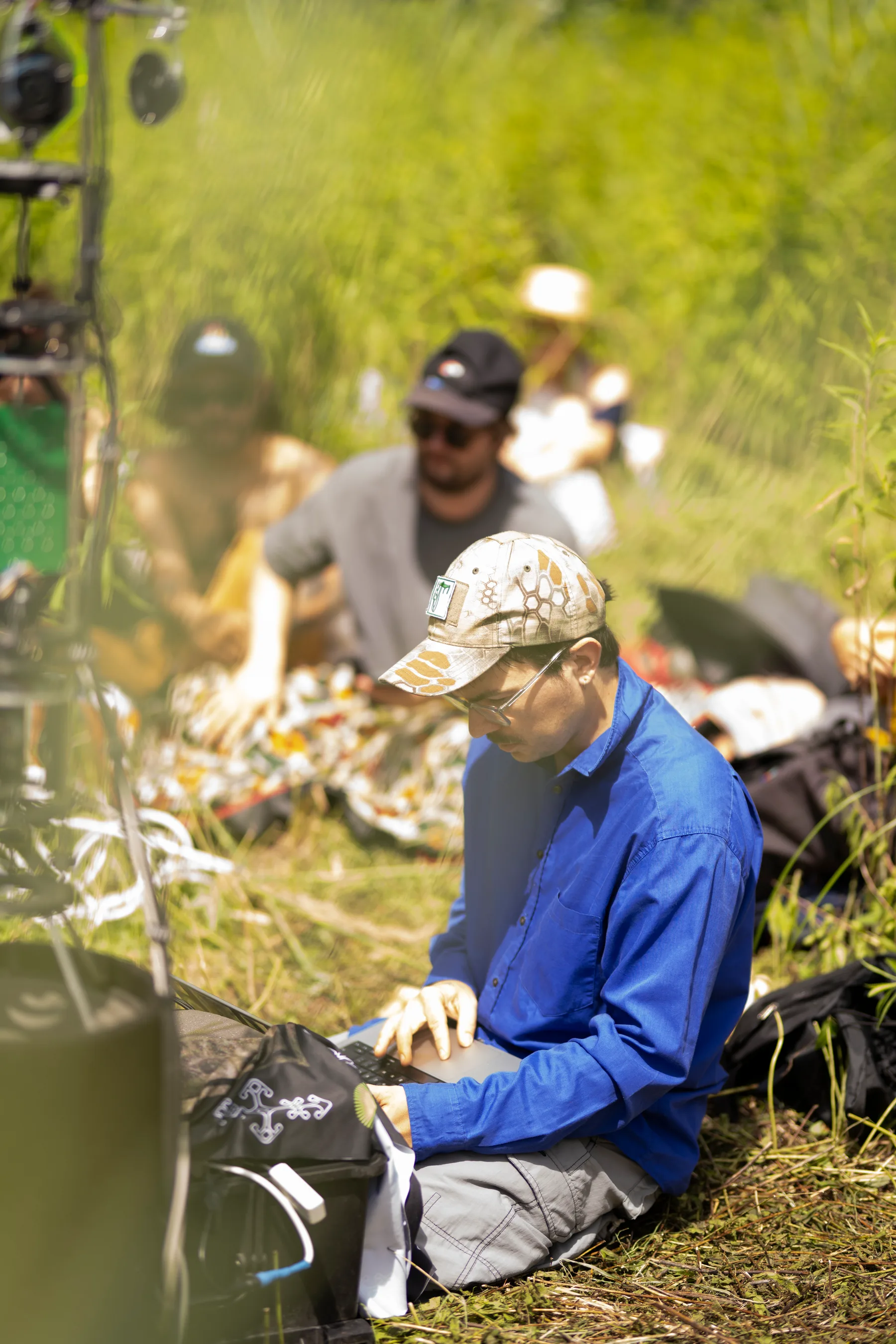 A participant operates a laptop among sound equipment during Less is Sound