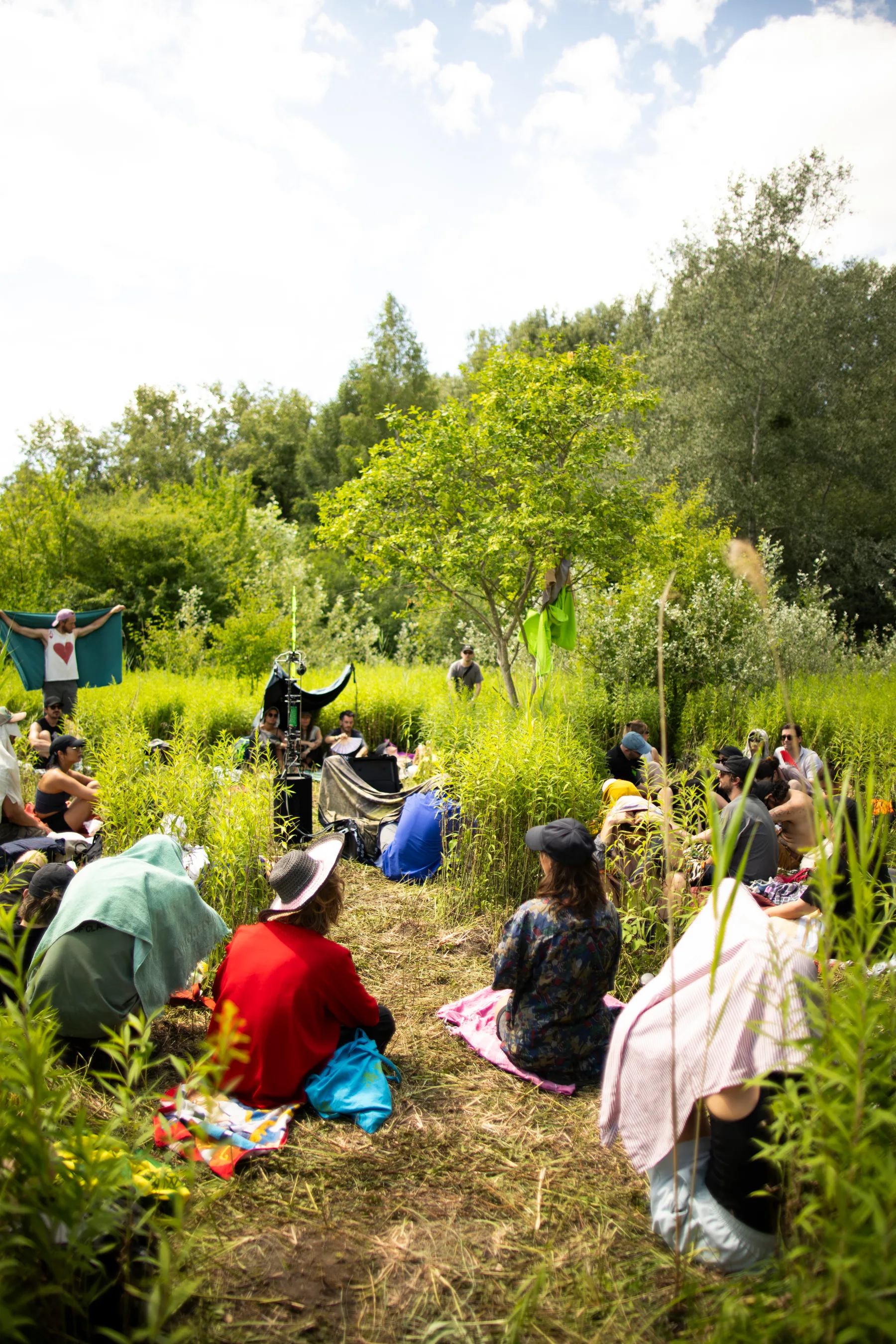 A seated group gathers for a collective listening activity at Less is Sound